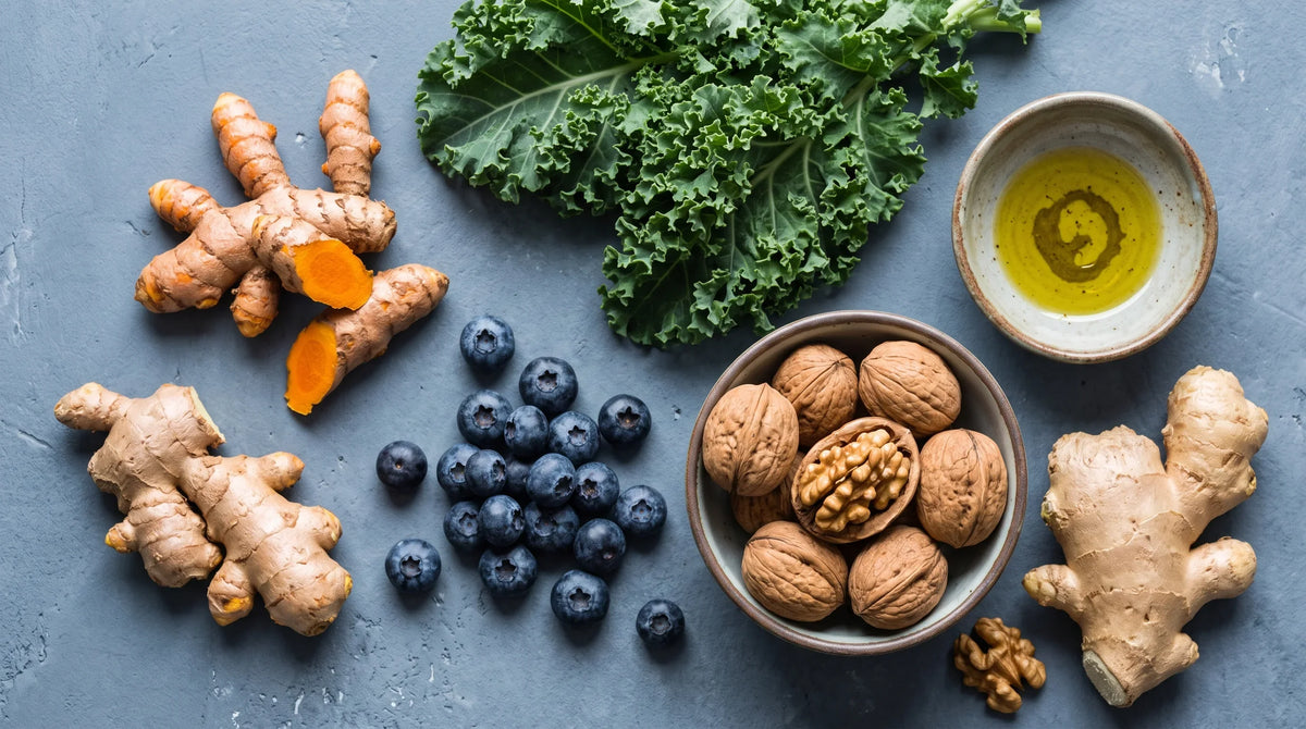 arrangement of anti-inflammatory foods on a cool slate grey surface: fresh turmeric root and ginger root - Natural Rhythm Nutrition